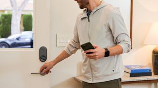 Man uses phone to unlock Yale Approach smart lock