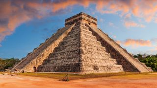 An ancient stone temple in Mexico as seen at sunset. 