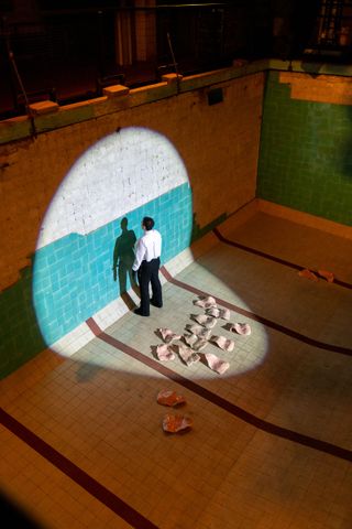 person in empty swimming pool as part of art performance at E-WERK Luckenwalde