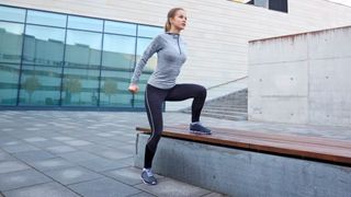 Woman doing a lateral step up outside