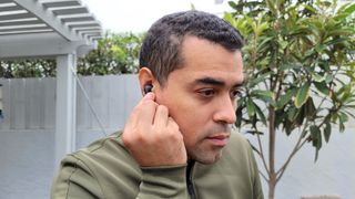 Man touching Samsung Galaxy Buds 2 in ears