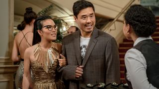 (L-R) Ali Wong as Sasha, locking arms with Randall Park as Marcus