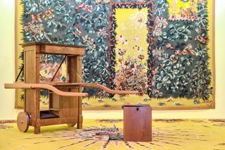 Museum interior in Toulon with yellow and blue tapestry and wooden furniture