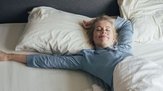 A woman stretches out on a mattress