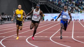 Christian Coleman (R) and other sprinters cross the line