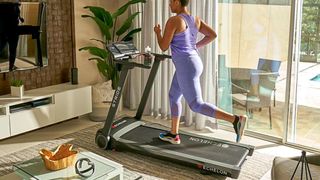 Woman running on the Echelon Stride treadmill