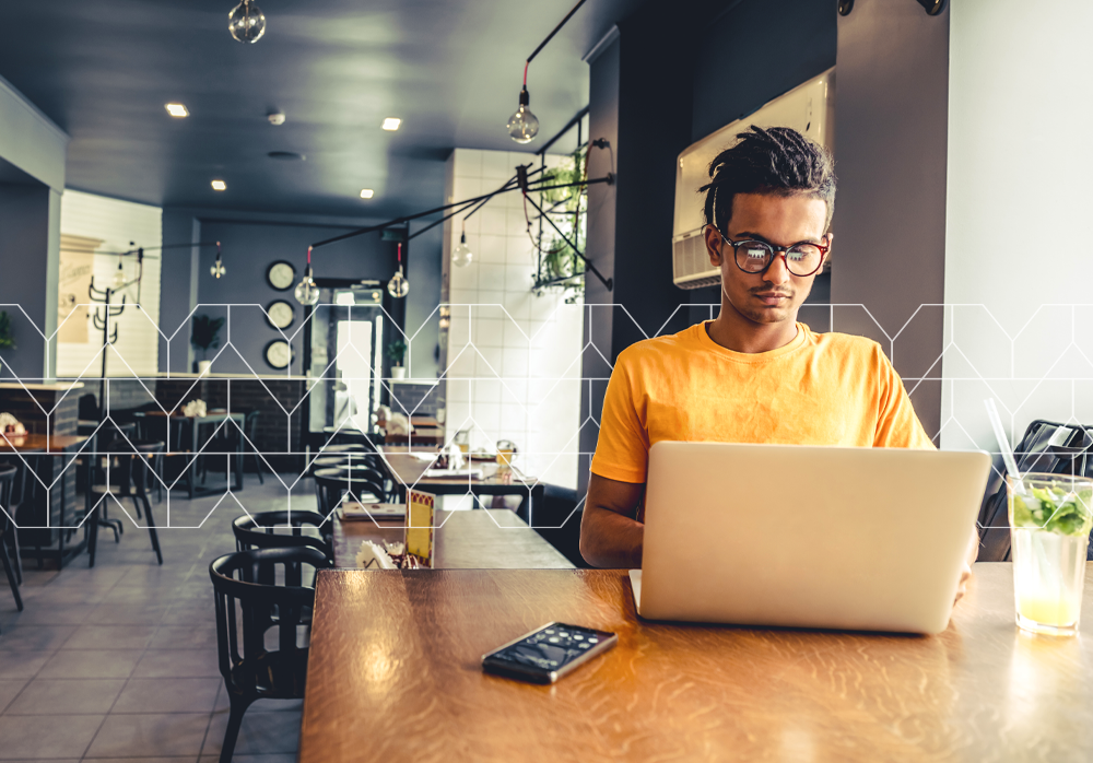 Man in a restaurant working on his laptop