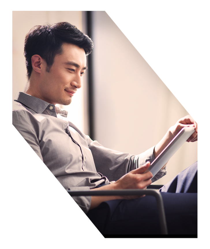 Man sitting in chair reading iPad