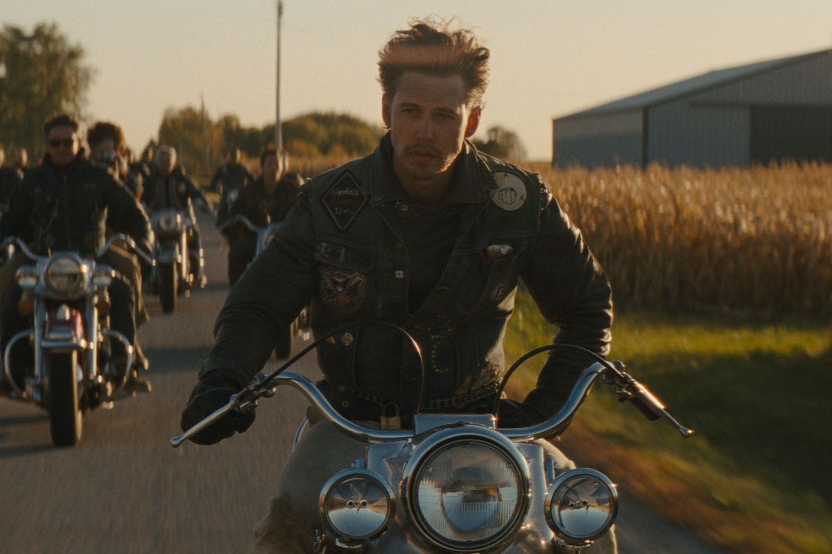 Austin Butler looks amazingly cool as he rides a motorbike one-handed, surrounded by his clubmates, in The Bikeriders