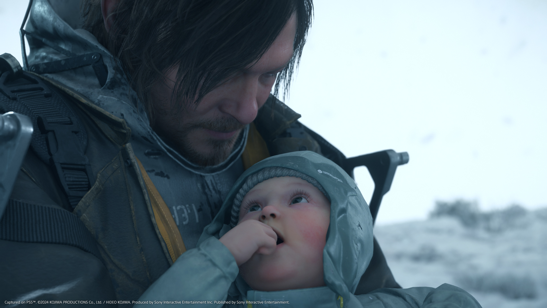 Sam (Norman Reedus) cradles baby Lou in close-up in Death Stranding 2