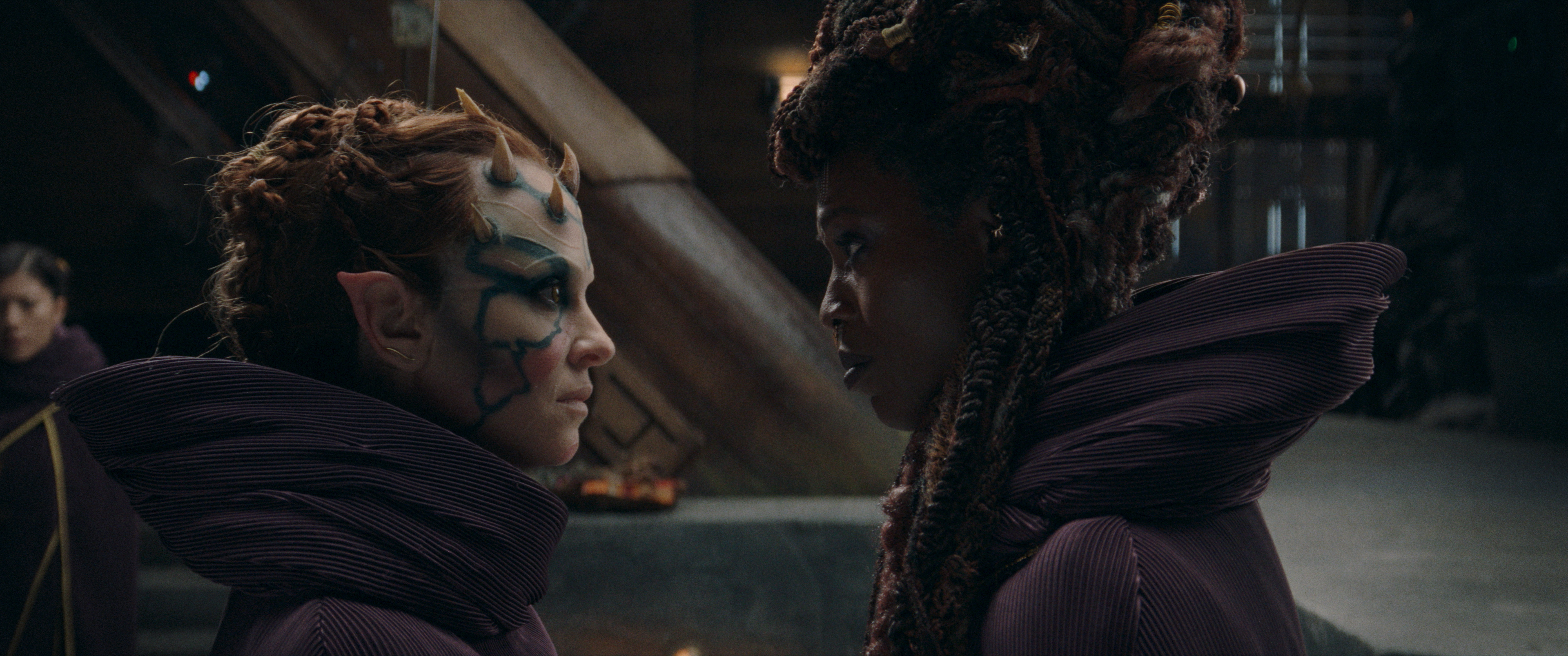 Mother Koril (Margarita Levieva) and Mother Aniseya (Jodie Turner-Smith) looking at each other up close