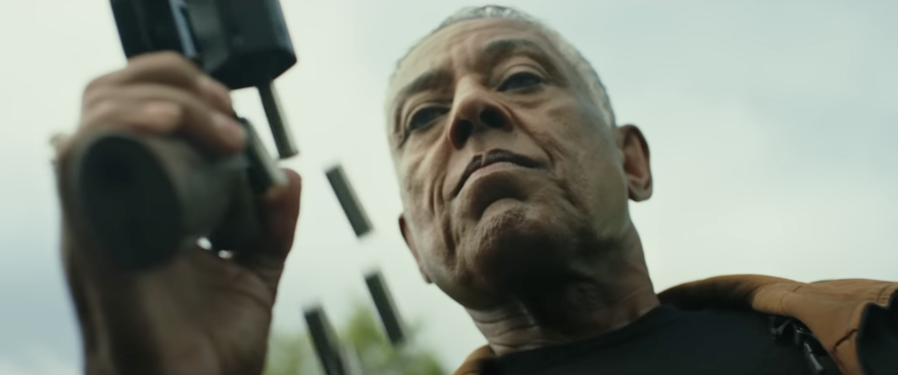 Giancarlo Esposito’s character in Captain America: Brave New World looks down his nose grimly as he ejects a rain of spent shells from his gun.