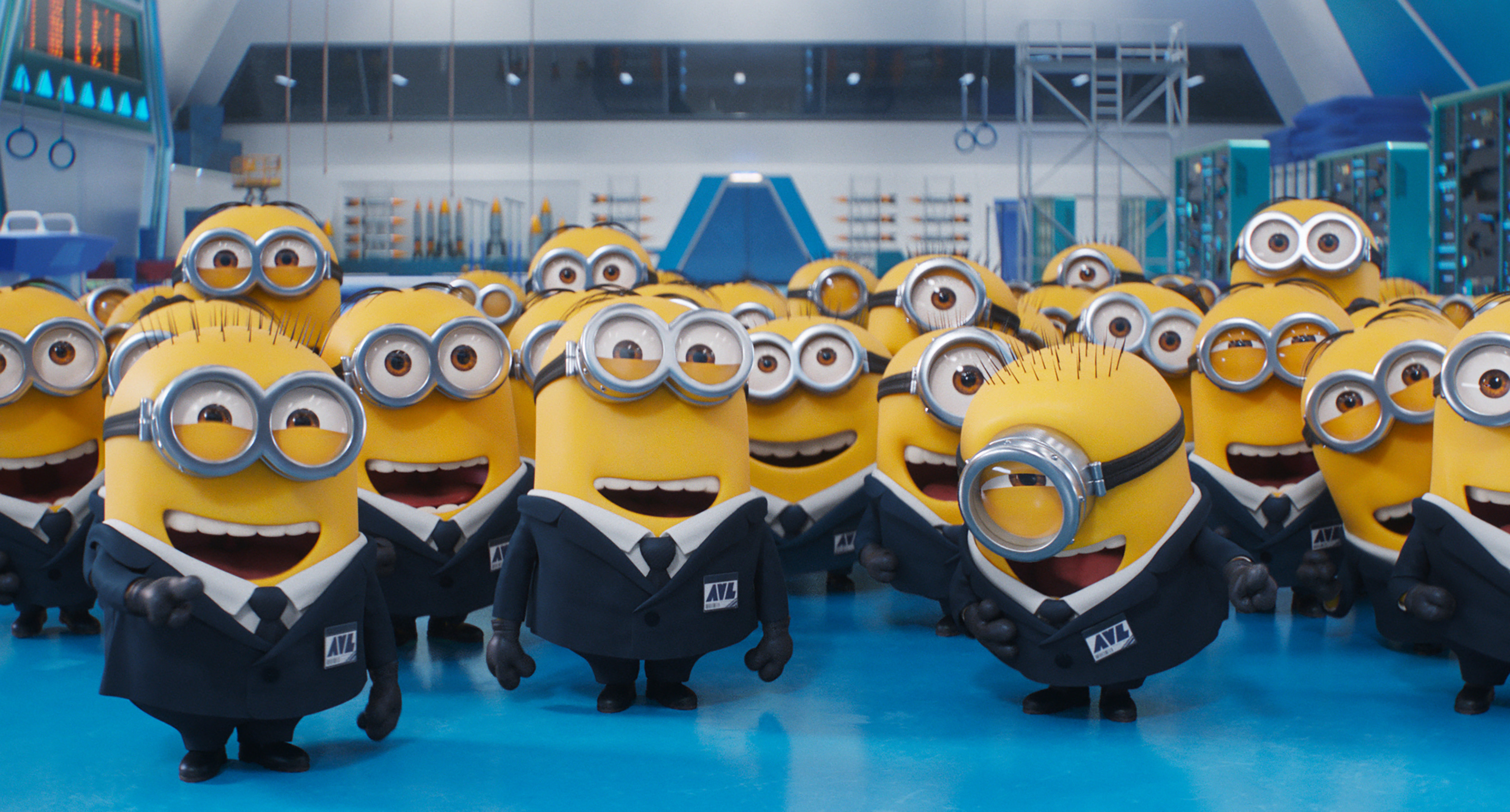 A group of Minions in suits and ties, laughing in an office