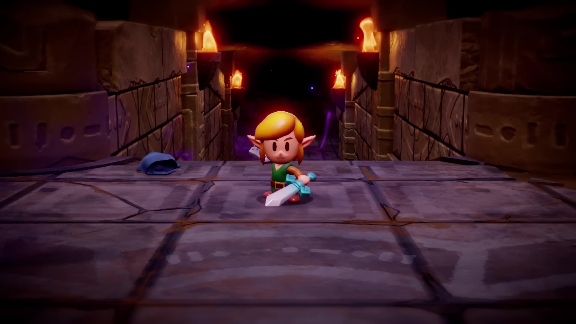 Link stands in a dungeon corridor with his sword out in The Legend of Zelda: Echoes of Wisdom