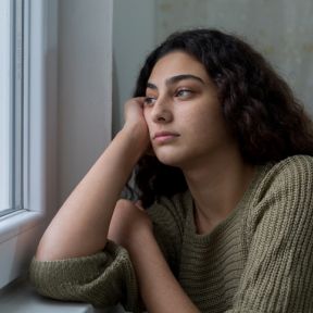 Woman looking out window