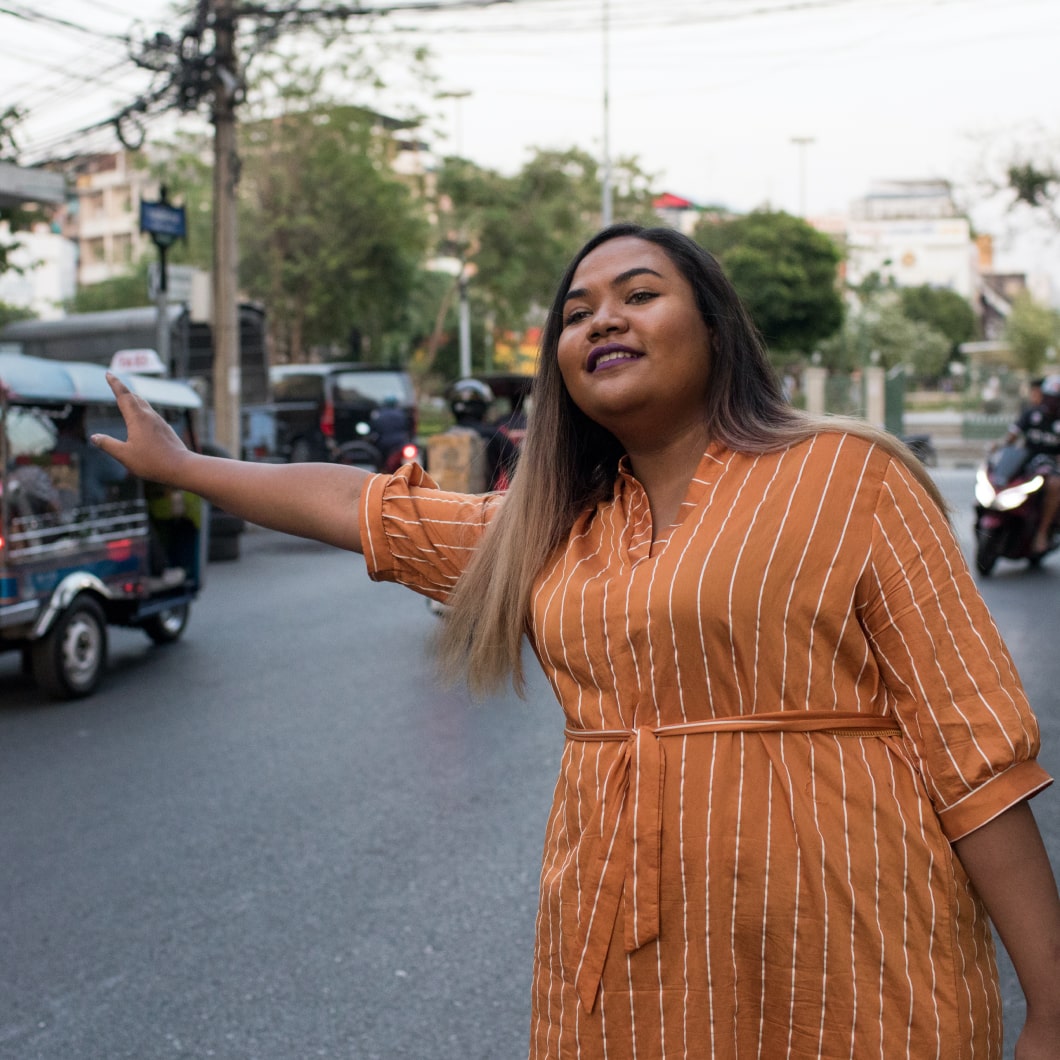 A traveller hailing a cab in a sunny destination