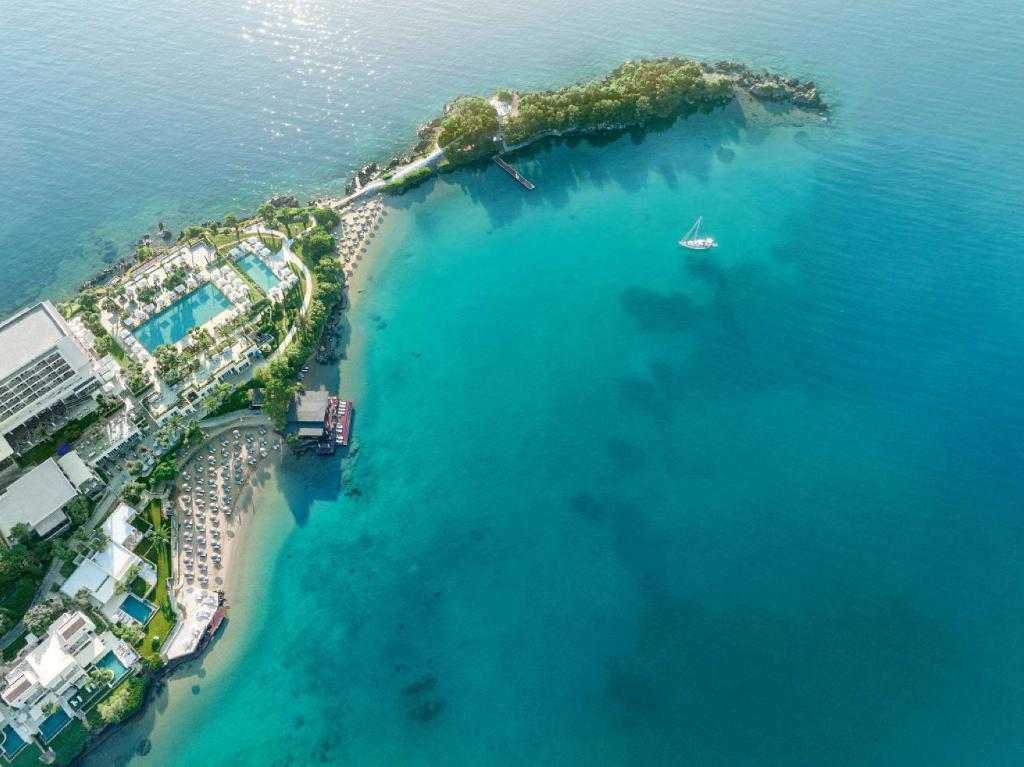 an aerial view of an island in the ocean at Corfu Imperial, Grecotel Beach Luxe Resort in Kommeno