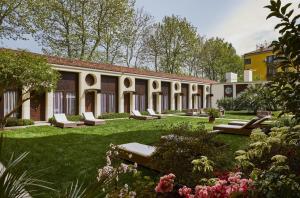 a courtyard of a building with benches and flowers at Hotel Indigo Venice - Sant'Elena, an IHG Hotel in Venice