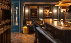 a bar with chairs and a long counter in a restaurant at The Wilder in Dublin