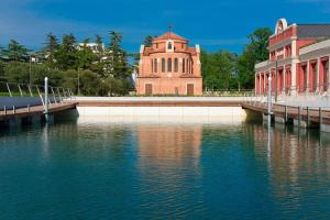 a building next to a body of water with a bridge at JW Marriott Venice Resort & Spa in Venice