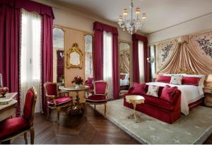 a bedroom with a bed and a red couch at The Gritti Palace, a Luxury Collection Hotel, Venice in Venice