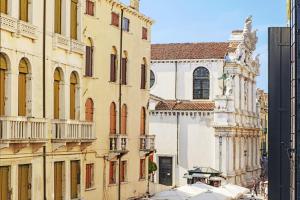 a building with a clock tower and a church at The Gritti Palace, a Luxury Collection Hotel, Venice in Venice