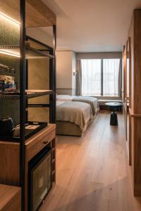 a bedroom with a bed and a large window at Wren Urban Nest in Dublin