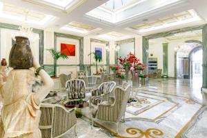 a woman in a room with chairs and a table at Aleph Rome Hotel, Curio Collection By Hilton in Rome