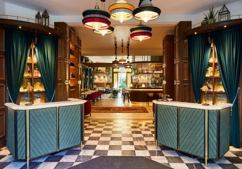 a restaurant with green curtains and a checkered floor at Hotel Indigo Venice - Sant'Elena, an IHG Hotel in Venice