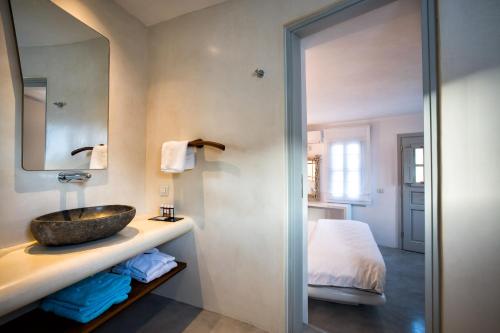 a bathroom with a sink and a bed at Blue Sand Boutique Hotel & Suites in Agali