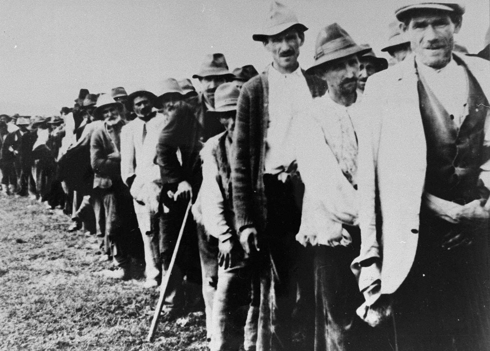 Serbs and Roma who have been rounded up for deportation are marched to the Kozara and Jasenovac concentration camps.