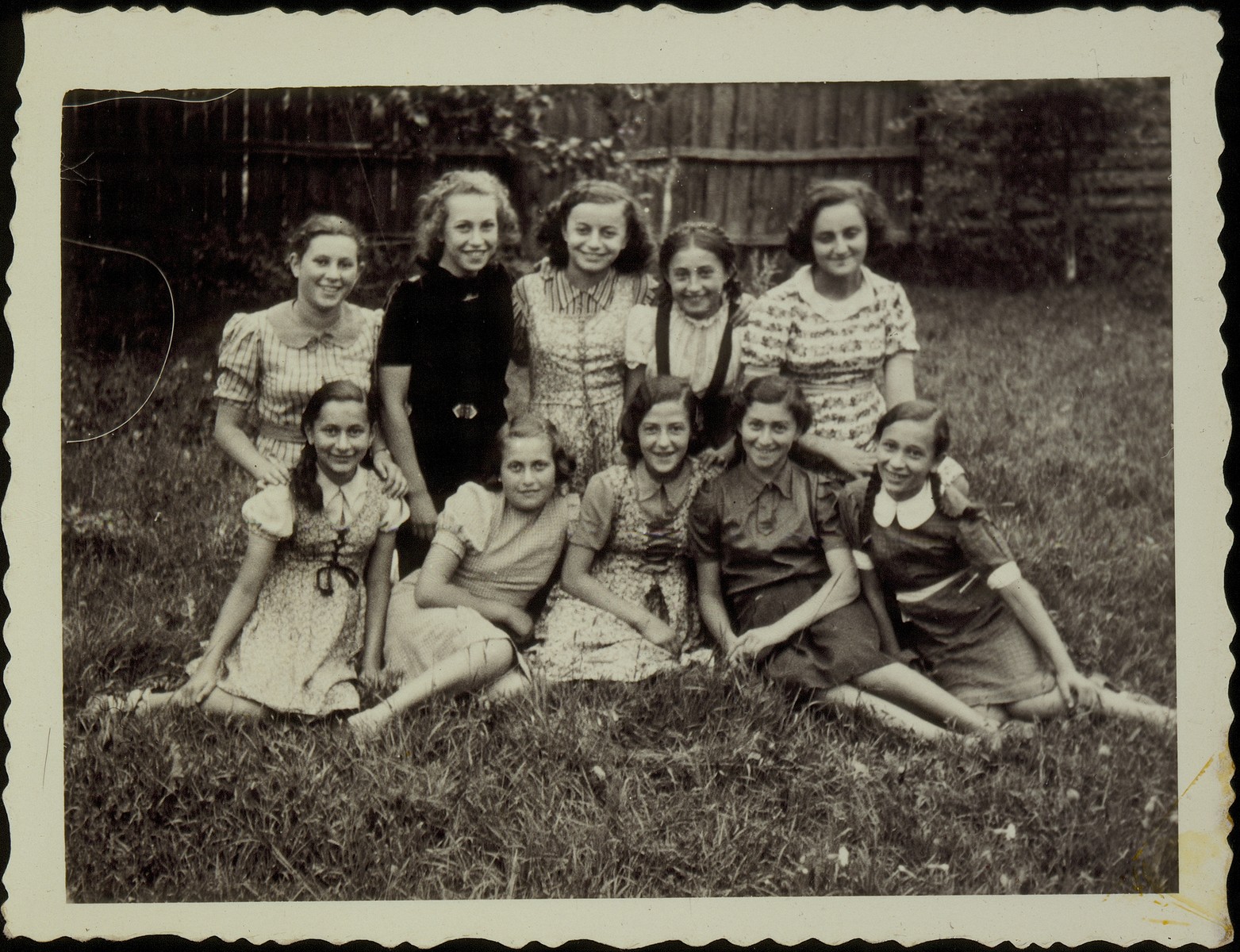 A group of young girls pose in a yard in the town of Eisiskes.  The Jews of this shtetl  were murdered by the Einsatzgruppen on September 21, 1941.