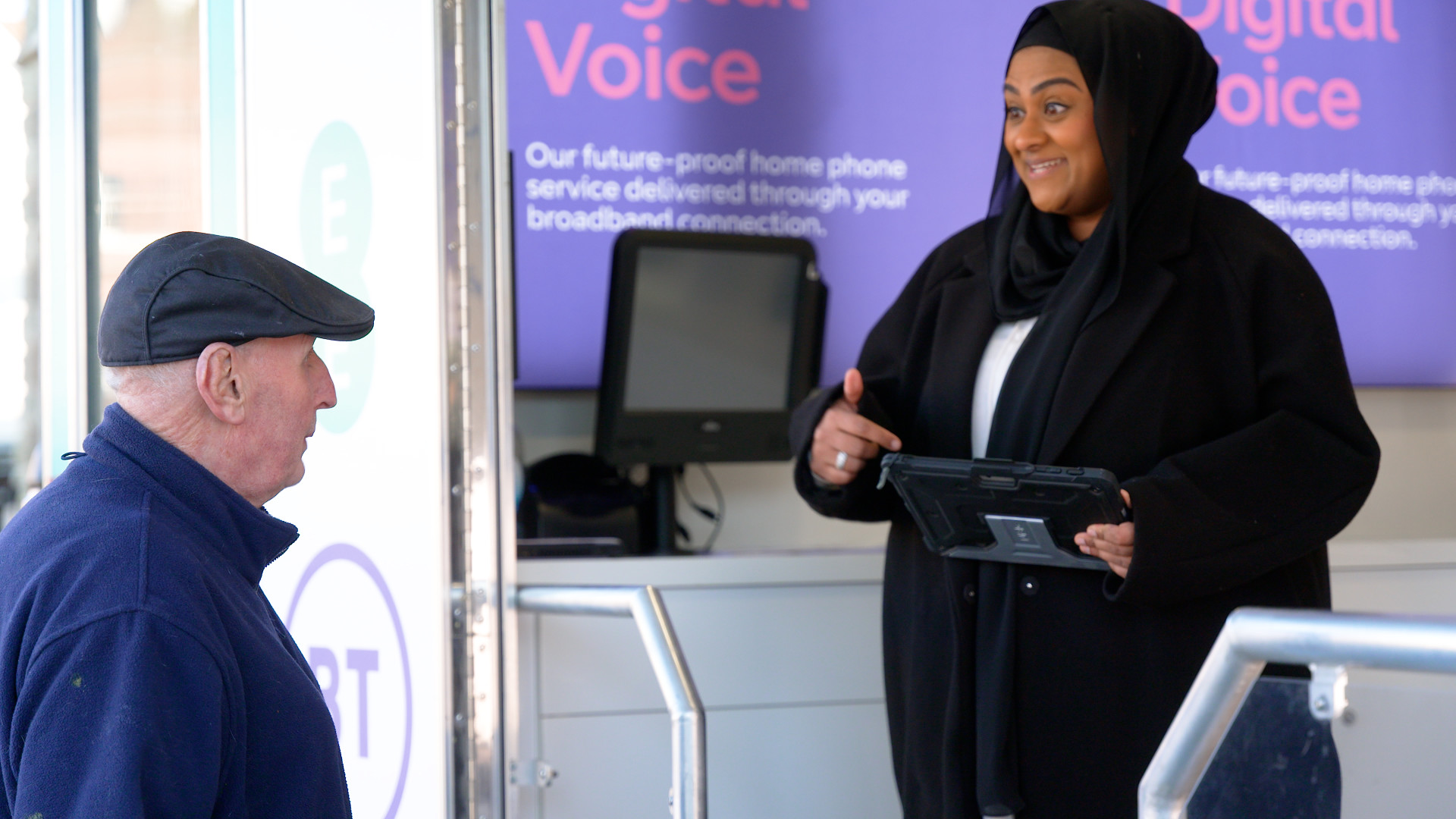 Customer service advisor helping customer at a Digital Voice demonstration vehicle