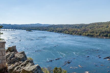 A wide river lined by forest.