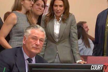 An emotional Alec Baldwin after the judge dismisses case. Baldwin's wife Hilaria is standing behind him