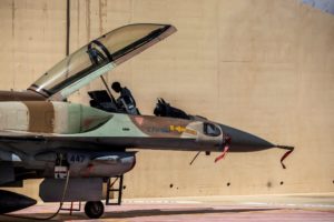 A soldier works on an Israeli F-16 fighter jet in an airbase in southern Israel