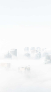 Fog enshrouds skyline blurring skyscrapers into a serene minimalist cityscape | App Background Maker