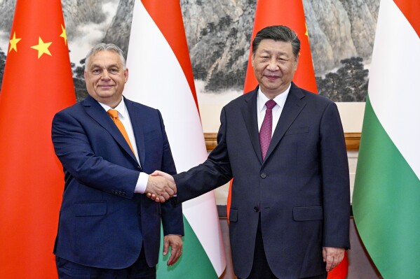 In this photo released by Xinhua News Agency, Hungarian Prime Minister Viktor Orban, left, shakes hands with Chinese President Xi Jinping before a meeting at the Diaoyutai State Guesthouse in Beijing, Monday, July 8, 2024. (Li Xueren/Xinhua via AP)