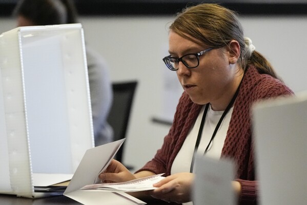 FILE - Elections assistant Mikayla Riley works in the processing center during early voting, Feb. 21, 2024, in Raleigh, N.C. (AP Photo/Mike Stewart, File)