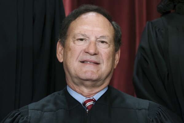 FILE - Associate Justice Samuel Alito joins other members of the Supreme Court as they pose for a new group portrait, Oct. 7, 2022, at the Supreme Court building in Washington. Alito rejects calls to step aside from Supreme Court cases on Trump and Jan. 6. (AP Photo/J. Scott Applewhite, File)