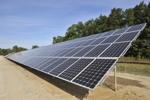 FILE - One of more than 4,000 solar panels constructed by DTE Energy lines a 9.37-acre swath of land in Ann Arbor Township, Mich., Sept. 15, 2015. Michigan will join four other states in requiring utility providers to transition to 100% carbon-free energy generation by 2040 under legislation that will soon be signed by Gov. Gretchen Whitmer. (Ryan Stanton/Ann Arbor News via AP, File)