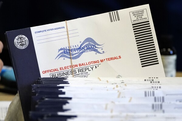 FILE - Chester County, Pa., election workers process mail-in and absentee ballots at West Chester University in West Chester, Pa., Nov. 4, 2020. (AP Photo/Matt Slocum, File)