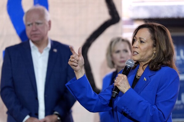 Democratic presidential nominee Vice President Kamala Harris, right, speaks as Democratic vice presidential nominee Minnesota Gov. Tim Walz, left, and his wife Gwen Walz listen at a campaign event, Sunday, Aug. 18, 2024, in Rochester, Pa. (AP Photo/Julia Nikhinson)