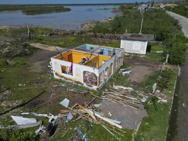 A house sits roofless after being damaged by Hurricane Beryl in Portland Cottage, Clarendon, Jamaica, July 4, 2024. (AP Photo/Leo Hudson)