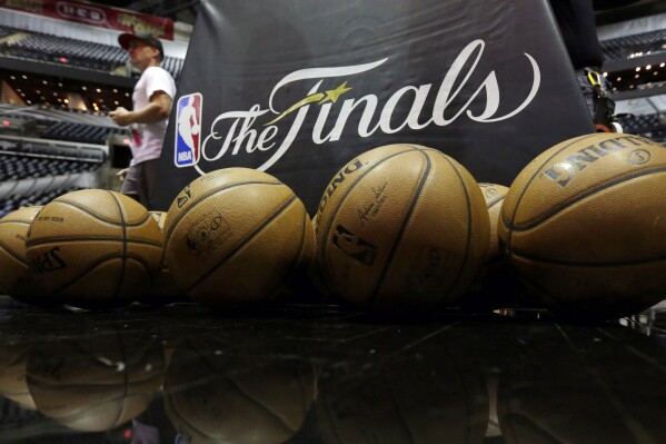 FILE - NBA basketballs and the NBA Finals logo are seen on the court prior to Game 1 of the NBA Finals basketball series between the San Antonio Spurs and Miami Heat, Thursday, June 5, 2014, in San Antonio. The NBA has agreed to terms on its new media deal, an 11-year agreement worth $76 billion that assures player salaries will continue rising for the foreseeable future and one that will surely change how some viewers access the game for years to come. (AP Photo/Eric Gay, File)