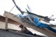 Work continues on the roof of Gaido's restaurant in preparation for opening for diners for the first time since Hurricane Beryl landed on Galveston Island six days prior on Saturday, July 13, 2024. (AP Photo/Annie Mulligan)