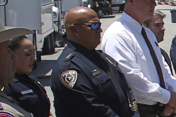 FILE - Uvalde School Police Chief Pete Arredondo, third from left, stands during a news conference outside of the Robb Elementary school on May 26, 2022, in Uvalde, Texas. (AP Photo/Dario Lopez-Mills, File)