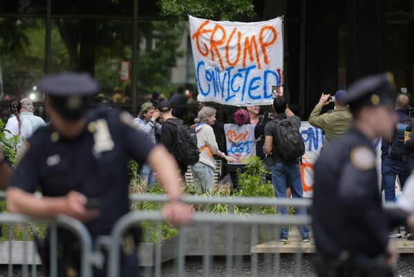 People react to the guilty verdict announced against former President Donald Trump outside Manhattan Criminal Court, Thursday, May 30, 2024, in New York. Donald Trump became the first former president to be convicted of felony crimes as a New York jury found him guilty of 34 felony counts of falsifying business records in a scheme to illegally influence the 2016 election through hush money payments to a porn actor who said the two had sex. (AP Photo/Seth Wenig)