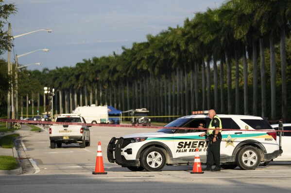 An officer with the Palm Beach County Sheriffs works outside of Trump International Golf Club after the apparent assassination attempt of Republican presidential nominee and former President Donald Trump, Monday, Sept. 16, 2024, in West Palm Beach, Fla. (AP Photo/Lynne Sladky)