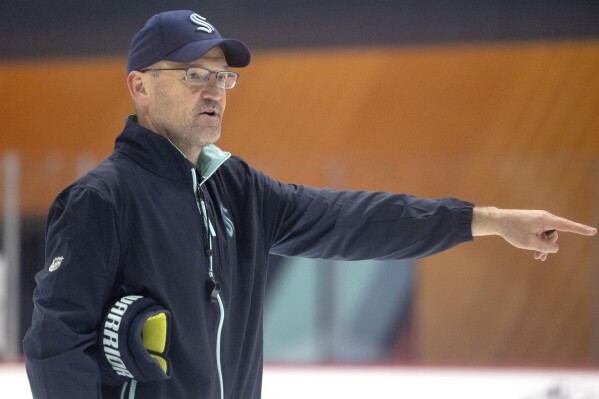 Seattle Kraken head coach Dan Bylsma directs players through a drill during a rookie development NHL training camp on Tuesday, July 2, 2024, in Seattle. Bylsma’s first on-ice duties as the Kraken head coach started Tuesday when the team began development camp for the top prospects in their system and concluded a wild five-week stretch for Bylsma.(Nick Wagne/The Seattle Times via AP)